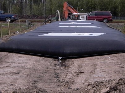 Dewatering bag being placed on berms