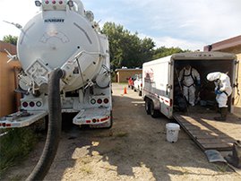 Workers cleaning digester