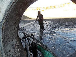 Worker cleaning digester